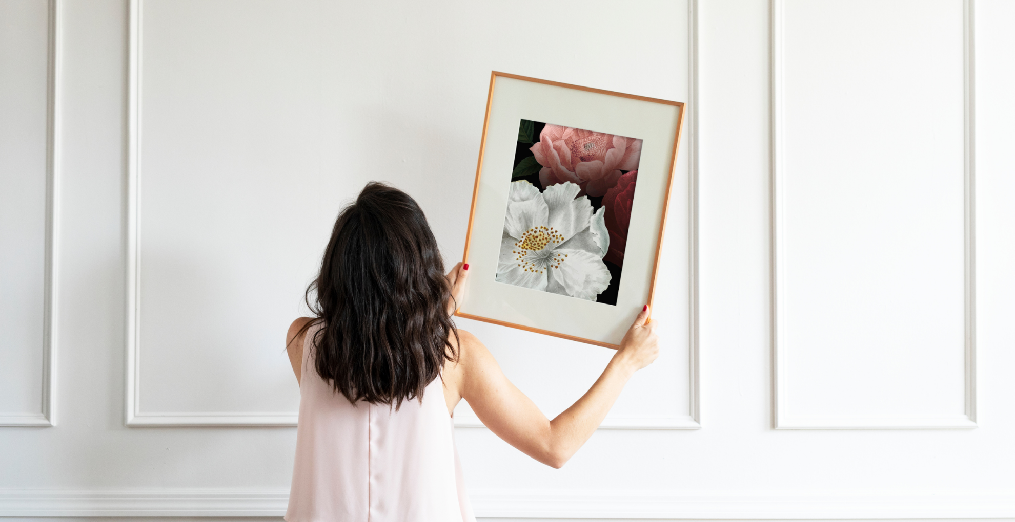 woman holding wall art
